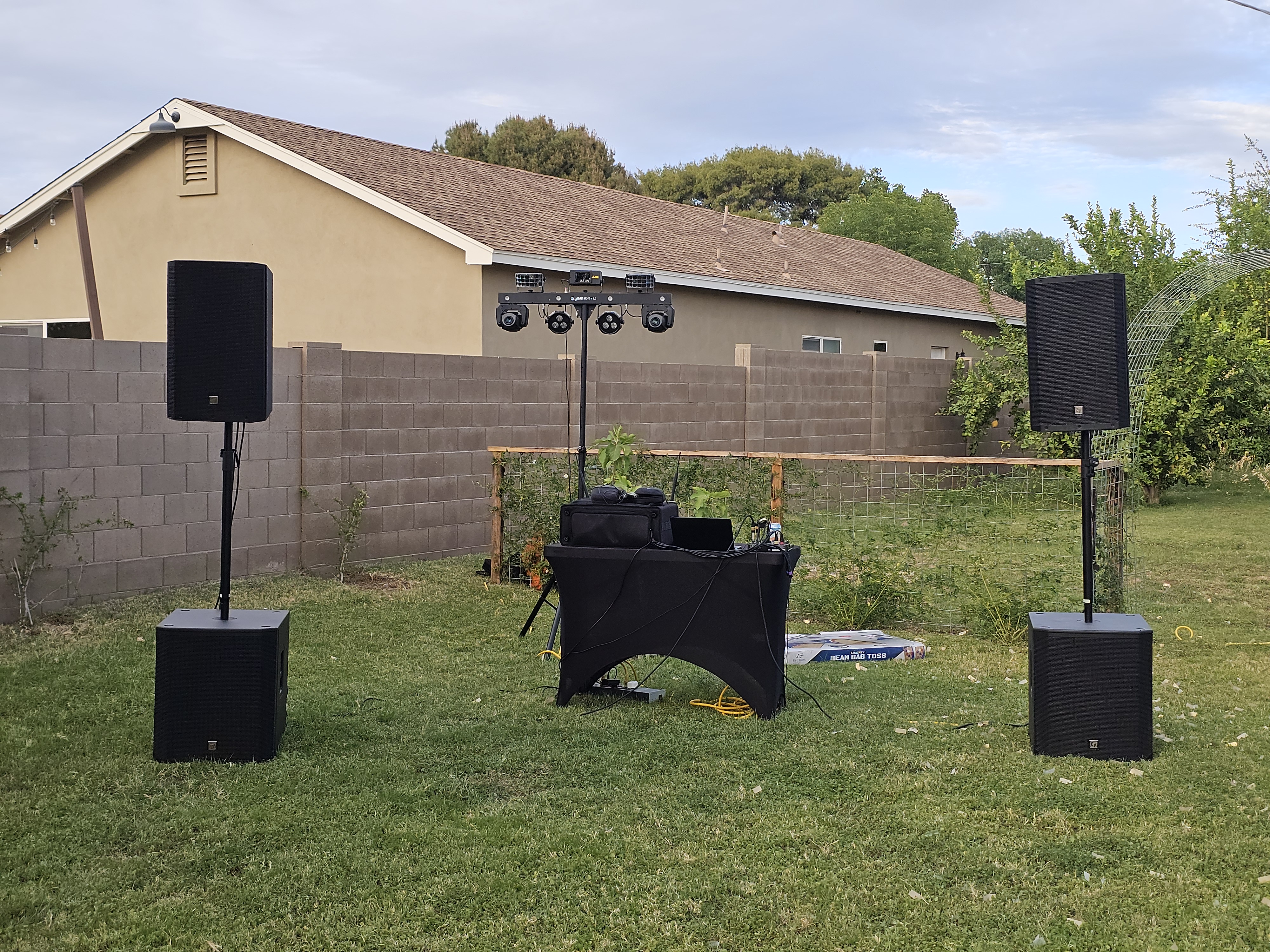 Clean DJ and speaker setup in a backyard
